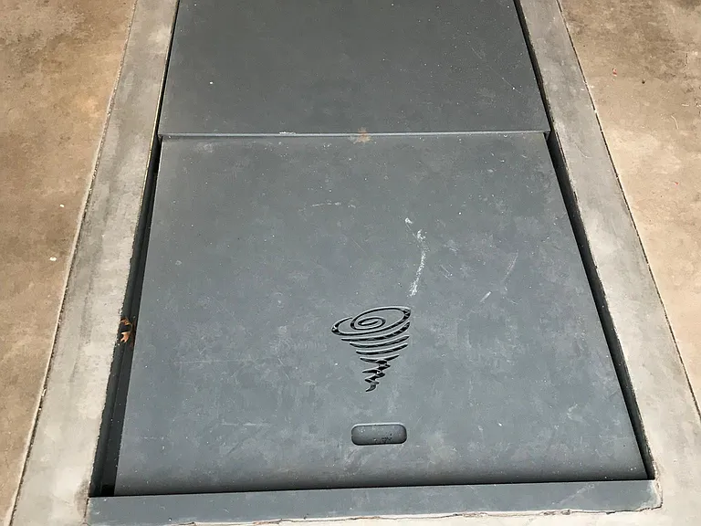 Storm shelter inside two car garage with work bench