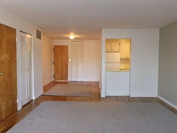 Open, Spacious Floor Plan. Area Carpets Protect Luxurious Hardwood Floors