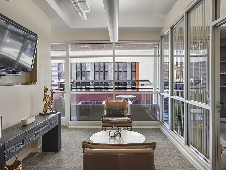 Our Apartment Building Interior Lobby overlooking the Common Area Patio at Sleek Lofts Apartments in Denver, Colorado