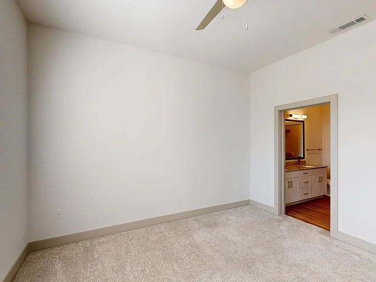 Spacious apartment Bedroom with Carpet Floor.
