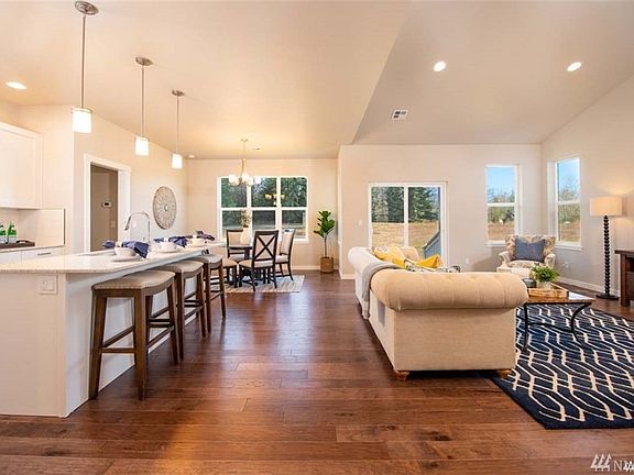 Wonderful great room/living area with plenty of window to enjoy close to a half acre lot.>