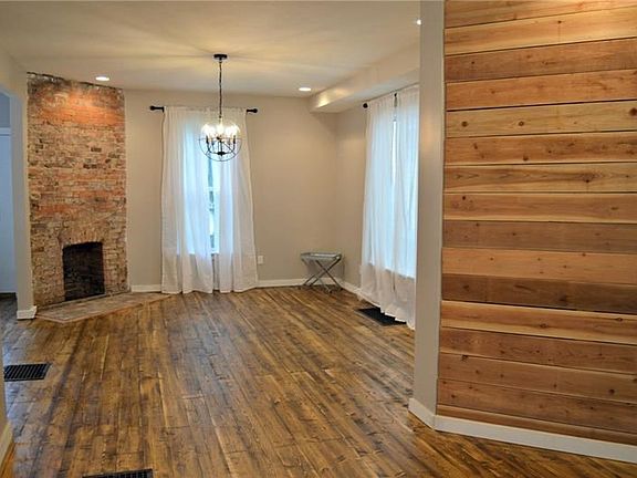 New Hardwood Floors, recessed lighting, exposed brick chimney