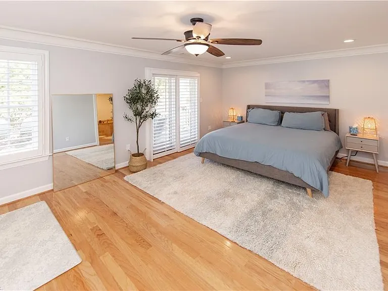 Master bedroom with king size bed, desk/working area, yoga/workout space, and a east facing private outdoor patio.