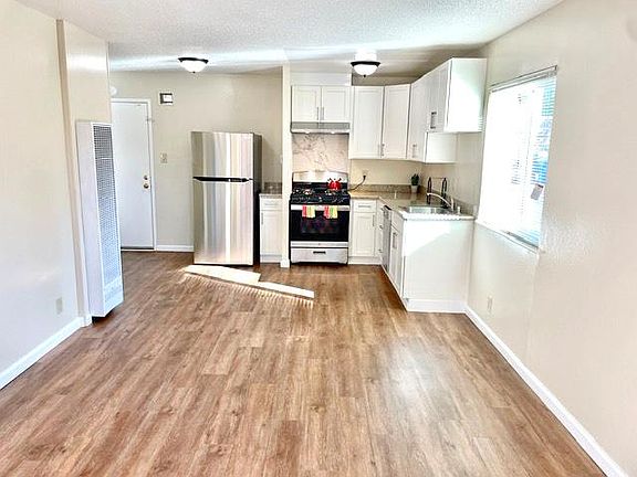 Living area looking toward kitchen and entry