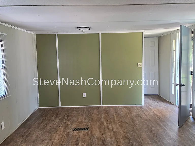 Den with Glass Door leading outside to front porch