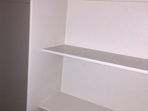 built-in shelving in hall closet