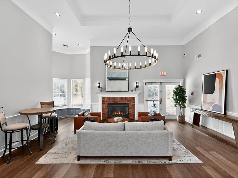 Step into elegance at Mansions at Delmar, an Eagle Rock Community. Our stylish common area features stunning architecture, a cozy fireplace, and ample natural light, perfect for relaxation or gatherings. Explore your new home today!