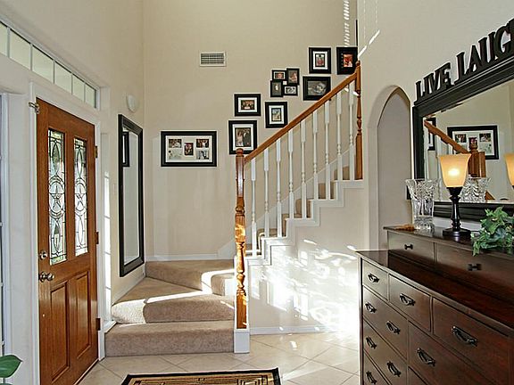 Enter into the large two story foyer, which is separate from the living areas.
