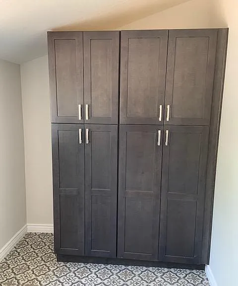 Storage galore. These double pantries can be used to store food on one side and cleaning supplies on the other. Located in the laundry room opposite the washer/dryer.