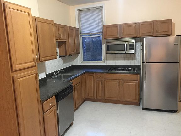 Open Kitchen with Dishwasher, Microwave, and Refrigerator.