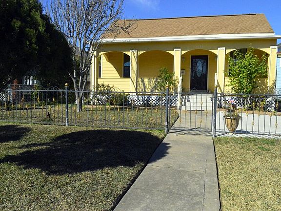 Large covered front porch and gated front yard.