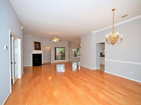 Open Floor Plan w/ beautiful flooring, fresh paint, crown moulding & chair railing in the dining room, gas log fireplace and recent mantel