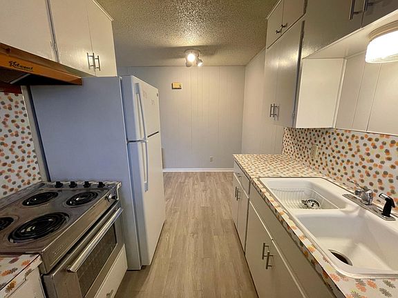 Galley kitchen with hip throwback vintage countertops.