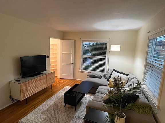 Living room closet door open and coffee table with lift top up