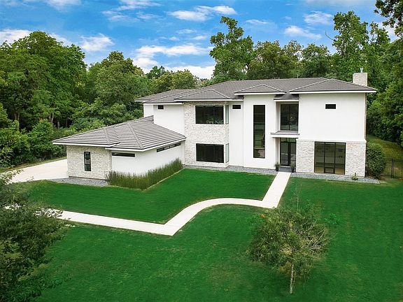 Architecture at it's best. This Benders Landing 1.3 acre home is on a very private cul-de-sac with easy access in and out of the neighborhood.