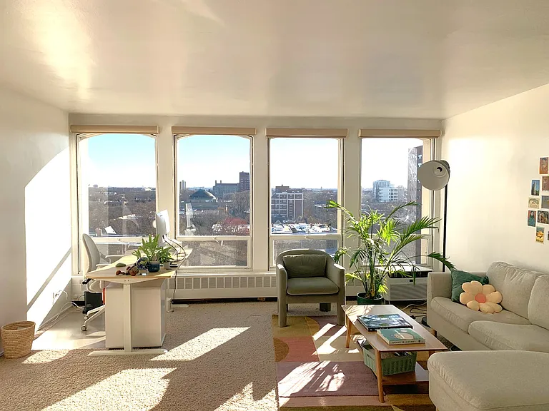 Spacious living room with spectacular view from the building's top floor.