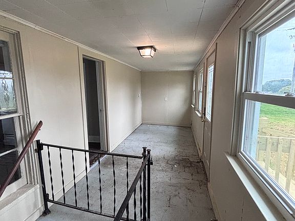 Enclosed porch and entry off the side of the house. Enters into kitchen. Basement access.