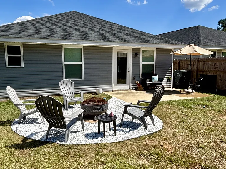 Fully fenced in back yard w/ fire pit