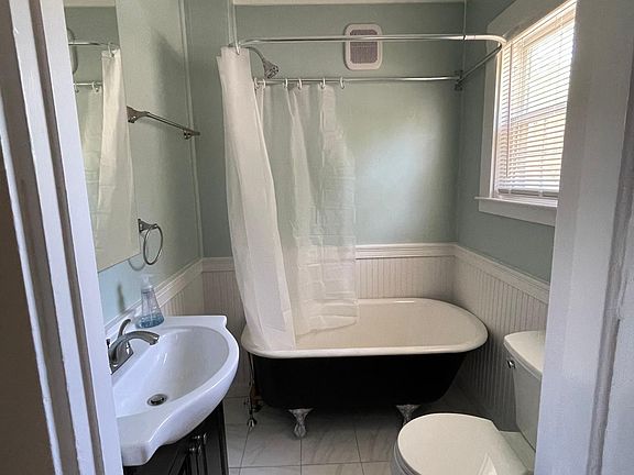 Newly renovated bathroom, tile floors, claw foot tub shower, luxury vanity and fixtures