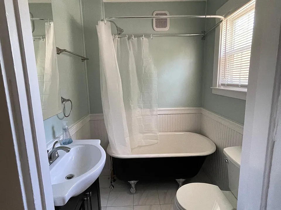 Newly renovated bathroom, tile floors, claw foot tub shower, luxury vanity and fixtures