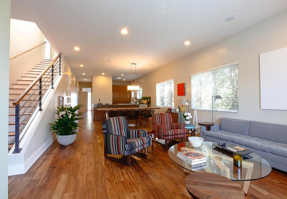 Living room, dinning room, kitchen. Downstairs bedroom with attached full bathroom, laundry room and exit to backyard and garages in the back.