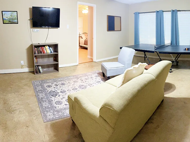 Game room with ping pong table, games, books, and TV