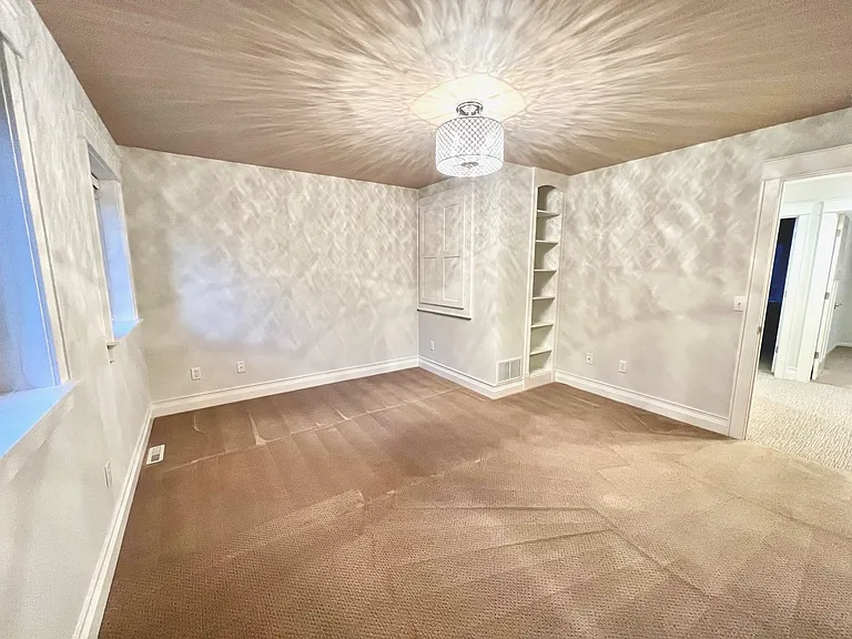 Upper level features a main bedroom suite with spacious walk-in closet, custom built-ins