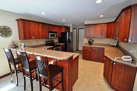 Kichen features many maple cabinets with cherry stain.