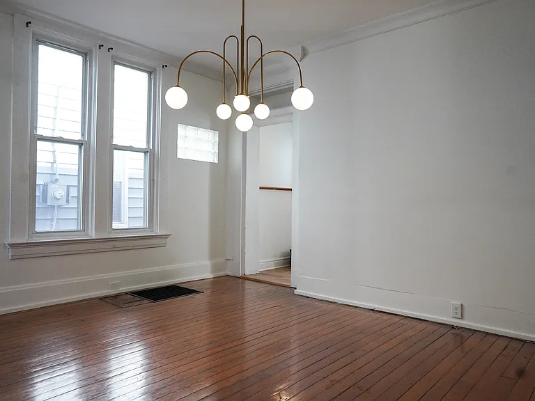Large dining room features natural light and an adjoining guest half bath.