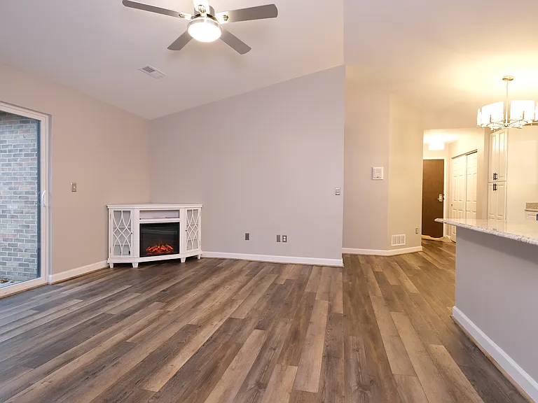 Living room and kitchen with sliding glass doors to the deck.