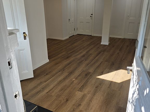 View inside the apartment while standing in the front door. The bathroom is to the right, you can see the doorknob.