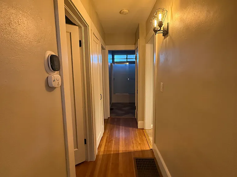Hallway to Master Bedroom/Spare Room and Bathroom. Additional entry to kitchen on right