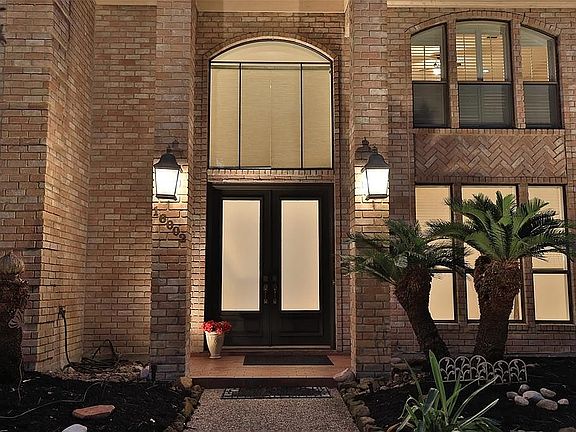 STUNNING ENTRY WITH DOUBLE DOORS - This grand entrance leads to a two story foyer with large window adding great natural lighting indoors. Notice the stunning carriage lights.
