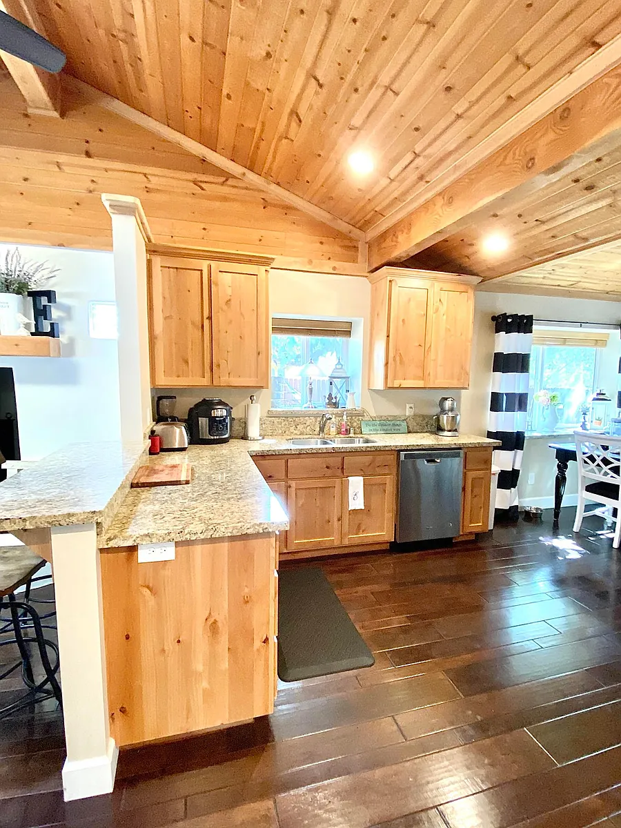 View of kitchen with granite countertops, beautiful cabinets and flooring, stainless steel appliances, gas cooktop, large dining area off kitchen. - 2245 Ceanothus Ave #2