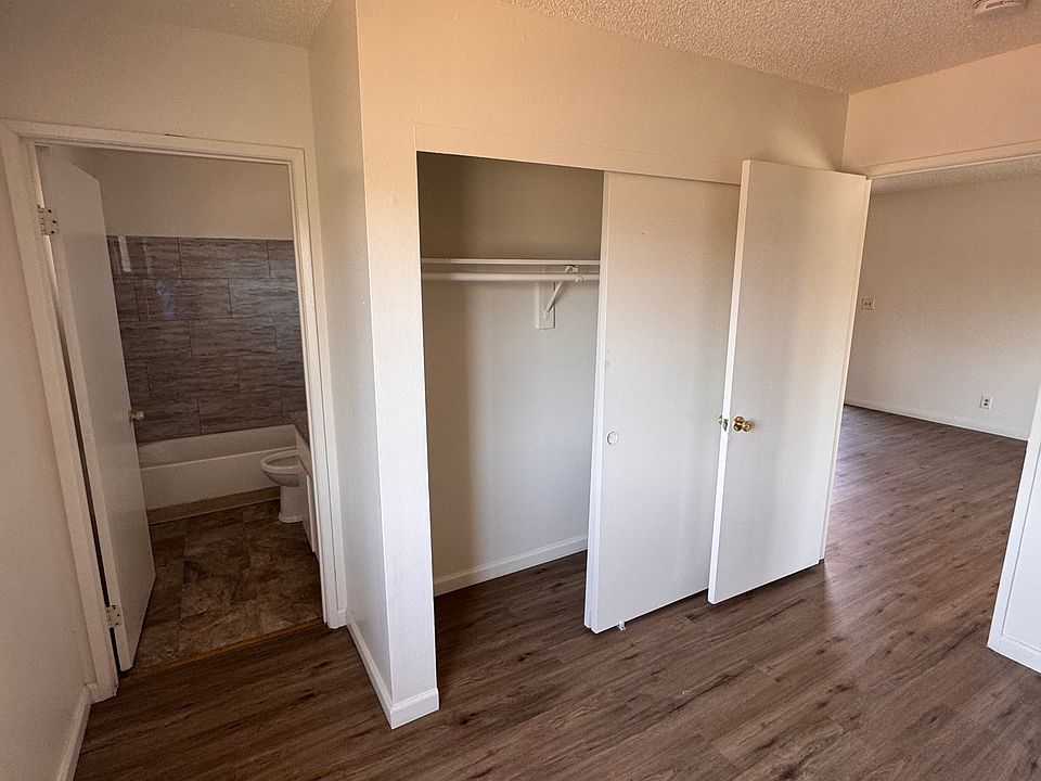 Bedroom with reach-in closet and adjoining bath