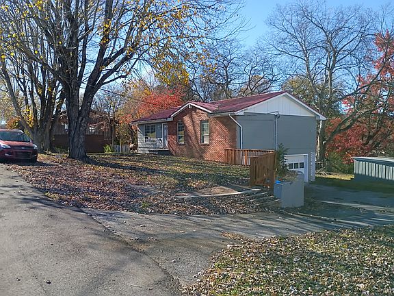 Side view, highlighting large driveway and ample parking