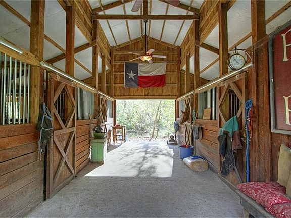 Outside, you will find a private barn (horses are permitted on this property), a recently installed 