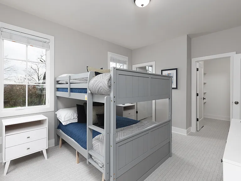 Bedroom 3 with a bunk bed, ensuite bathroom, Smart TV and dresser for your belongings. Also includes a walk-in closet. Located on the 2nd floor.