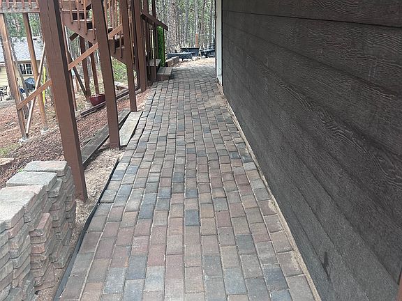 Path on the side of the house to stairs leading to apartment deck and kitchen door