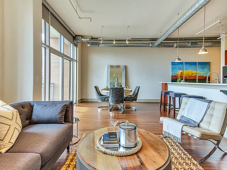 Spacious open concept floor plans with large living room and dining area with hardwood style flooring