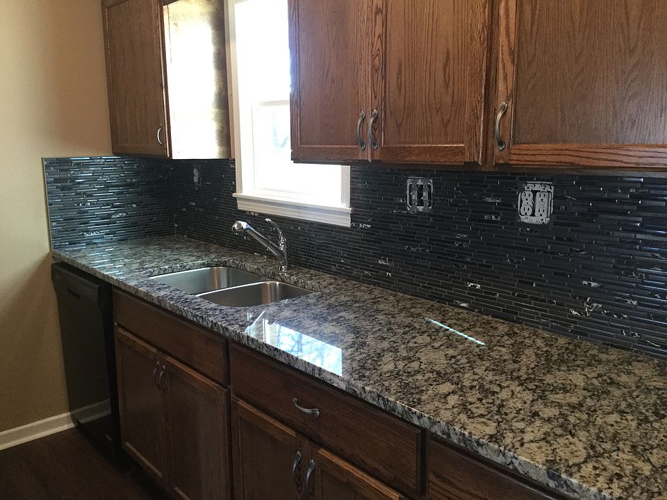 Granite counter top with black mosaic back splash