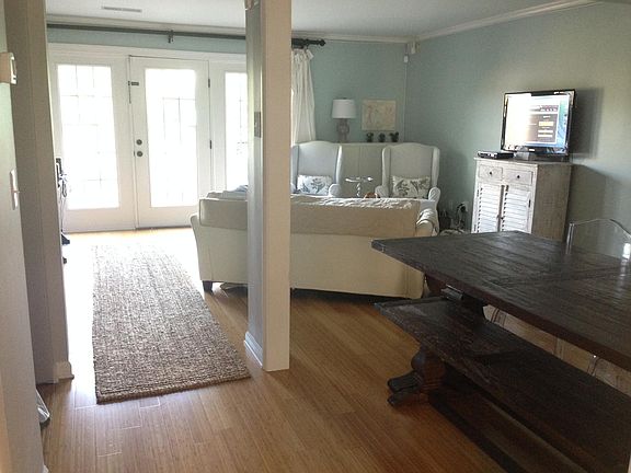 Dining room and living room with door to back deck
