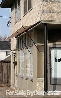 Front awning detail
						:
						Sun awning rolls up and down to control light into front windows.