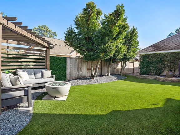 Relaxing, manicured backyard w/incredibly lush shaped trees, custom gazebo, firepit, raised beds w/fountain surrounded by rock & stone for maintenance free gardening.