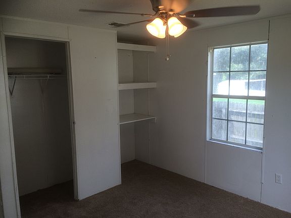 Large bedroom with new ceiling fan/lights, carpet, and fresh