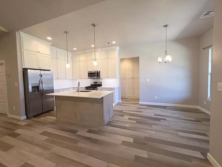 The warm hues of the home are inviting.
The hallway to the two bedrooms opens to beautiful cabinets of storage.