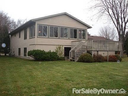 Backyard left view
						:
						Deck and spacious yard. Windows are in 3 seasons porch.