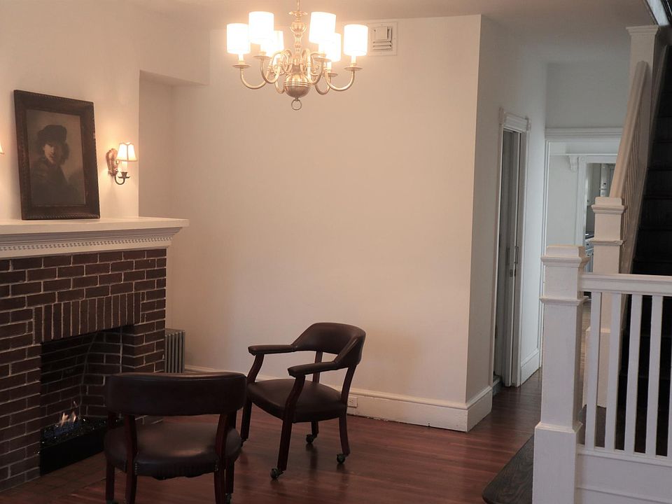 Living Room Fireplace with Black Fireglass. Bathroom Door is in the Hall.