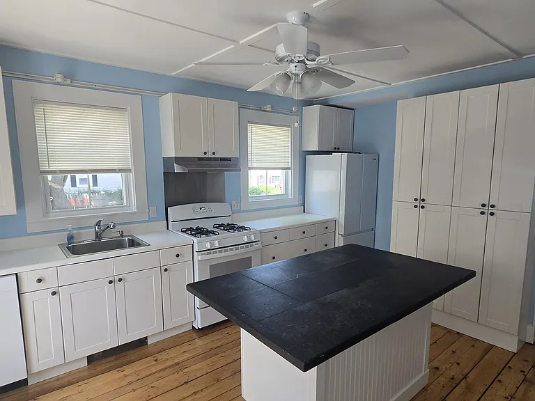 Kitchen with new gas stove, new dishwasher and island.