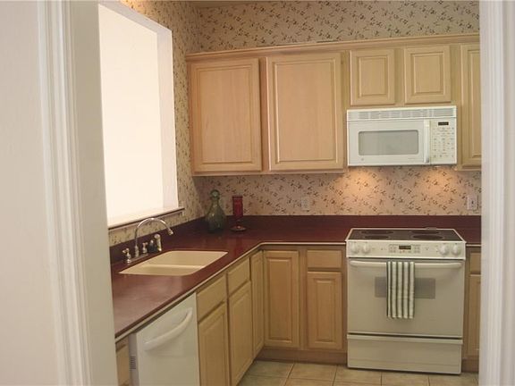 Kitchen is roomy with lots of storage.